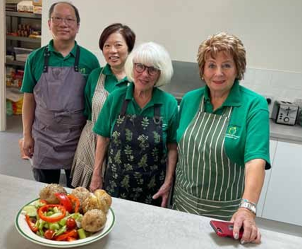 Volunteers in the kitchen preparing lunch